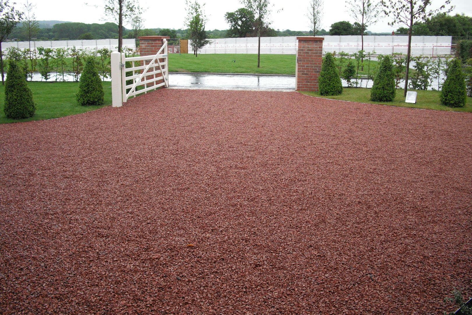 Gravel driveway in front of gates